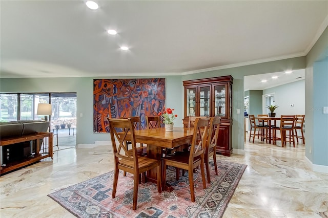 dining space with ornamental molding