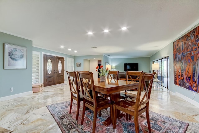 dining room featuring crown molding