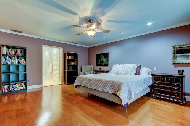 bedroom with ensuite bath, light wood-type flooring, ceiling fan, and crown molding