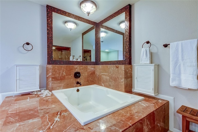 bathroom with a relaxing tiled tub