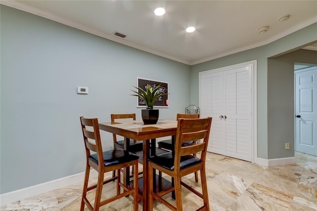 dining area featuring crown molding