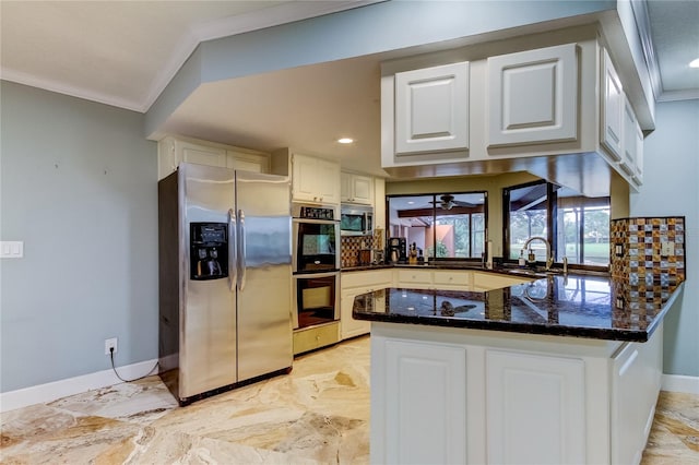 kitchen featuring kitchen peninsula, white cabinets, ornamental molding, and stainless steel appliances