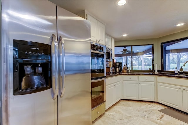 kitchen featuring white cabinets, appliances with stainless steel finishes, sink, and ceiling fan