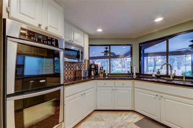 kitchen featuring white cabinetry, appliances with stainless steel finishes, sink, and ceiling fan