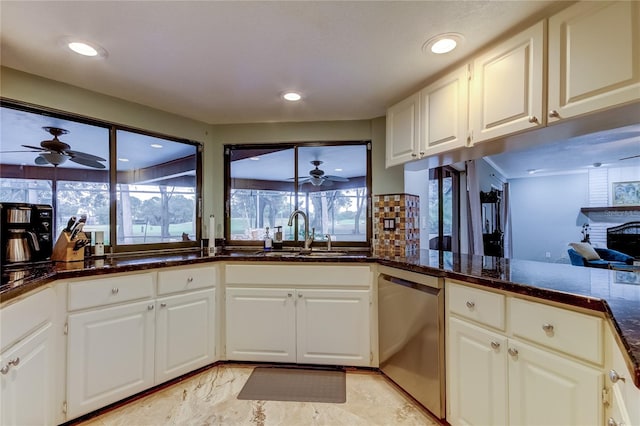 kitchen featuring white cabinetry, sink, a healthy amount of sunlight, and stainless steel dishwasher