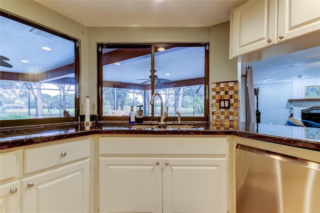 kitchen featuring white cabinetry, sink, ceiling fan, and stainless steel dishwasher