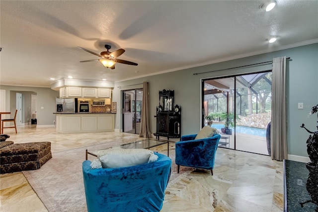 living room with a textured ceiling, ceiling fan, and crown molding