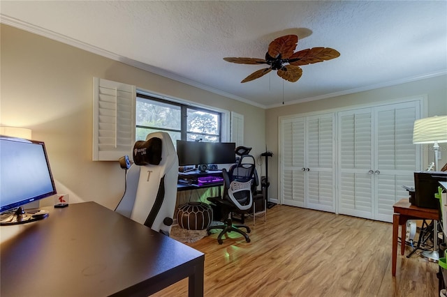 office space featuring ceiling fan, a textured ceiling, light hardwood / wood-style flooring, and ornamental molding