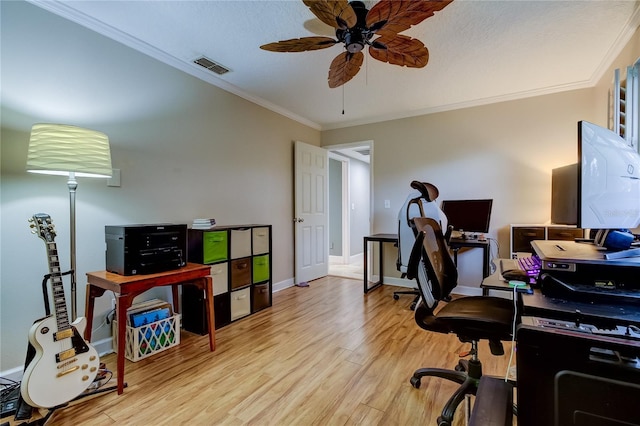 home office featuring ceiling fan, crown molding, and light hardwood / wood-style flooring