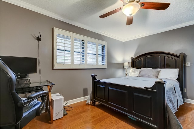 bedroom with light wood-type flooring, ceiling fan, and crown molding