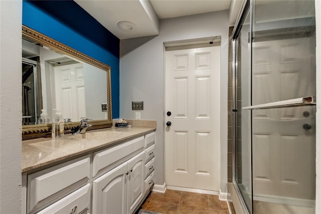 bathroom with vanity, an enclosed shower, and tile patterned flooring