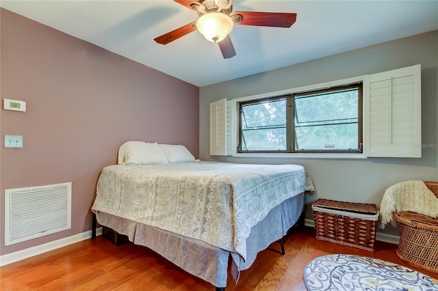 bedroom with wood-type flooring and ceiling fan