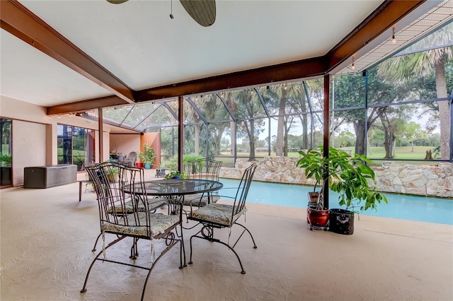 sunroom featuring a wealth of natural light and beam ceiling