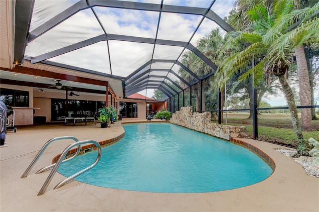 view of pool featuring a lanai, ceiling fan, and a patio