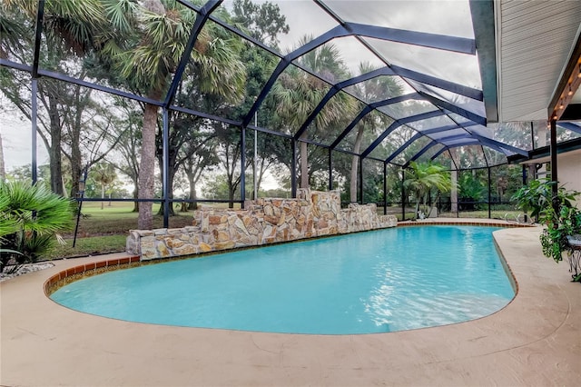 view of swimming pool with a lanai and a patio