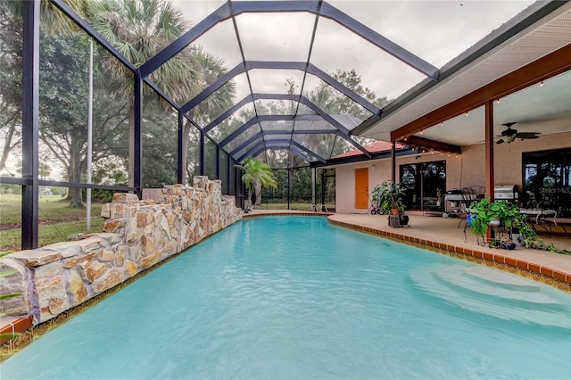 view of pool featuring ceiling fan, a lanai, and a patio