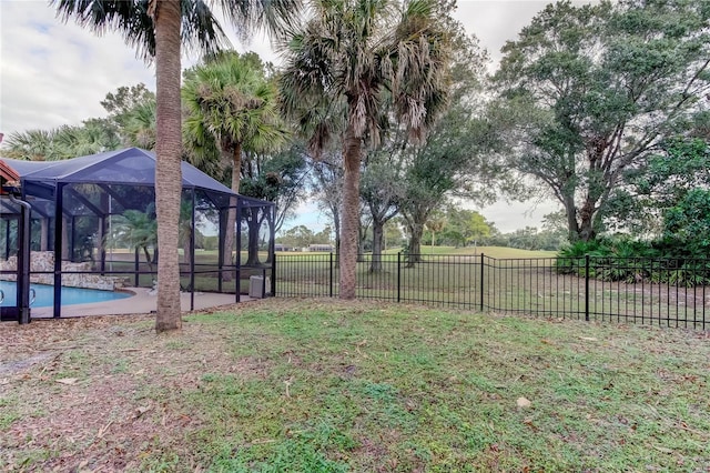 view of yard with a lanai and a fenced in pool