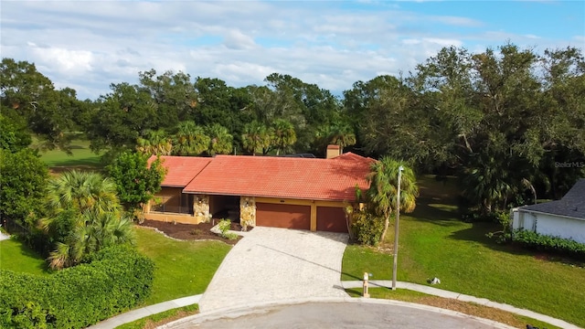 single story home featuring a garage and a front yard