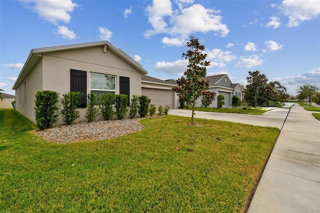 ranch-style home with a front yard and a garage