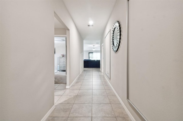 hallway featuring light tile patterned floors