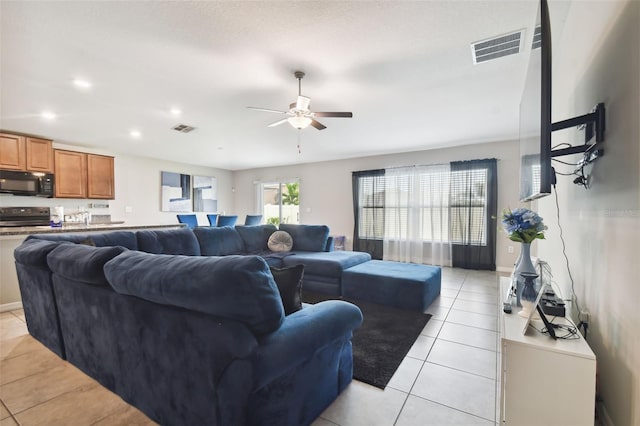 living room featuring ceiling fan and light tile patterned floors