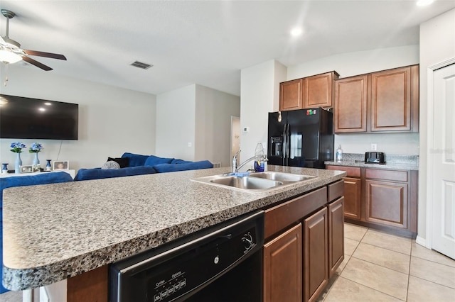 kitchen with black appliances, sink, light tile patterned floors, a kitchen island with sink, and ceiling fan