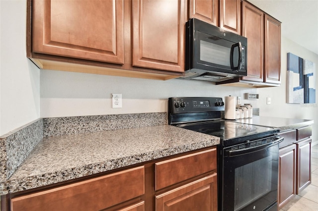 kitchen with light tile patterned floors and black appliances