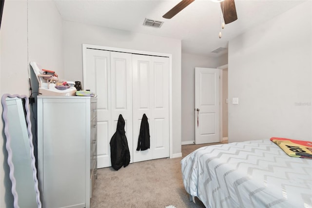 carpeted bedroom with ceiling fan and a closet