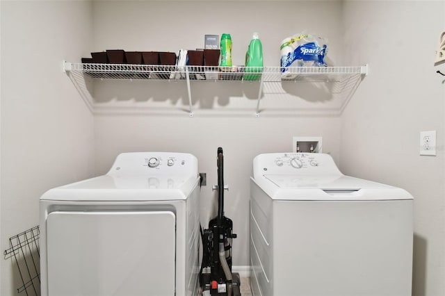 clothes washing area with washing machine and clothes dryer