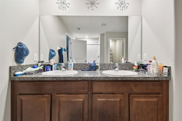 bathroom featuring vanity and a shower with door