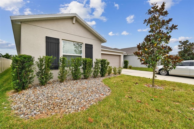 single story home featuring a garage and a front lawn