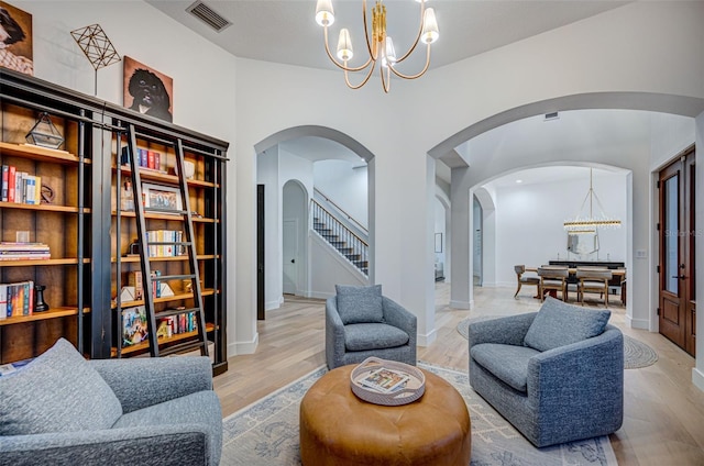 sitting room with a notable chandelier and light wood-type flooring