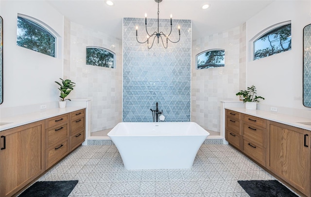 bathroom with vanity, tile walls, tile patterned floors, and plus walk in shower