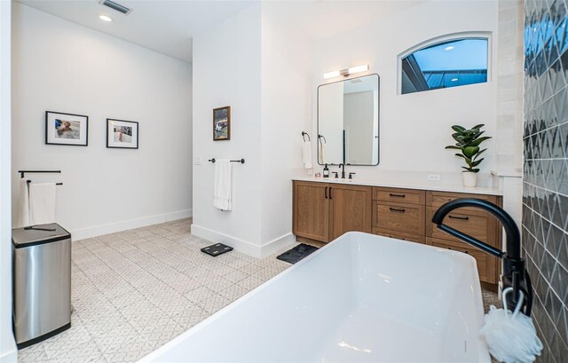 bathroom with vanity and a bathtub