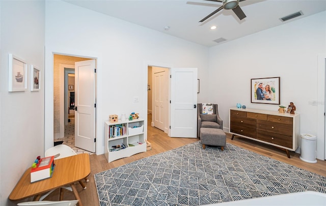 sitting room with hardwood / wood-style flooring, high vaulted ceiling, and ceiling fan