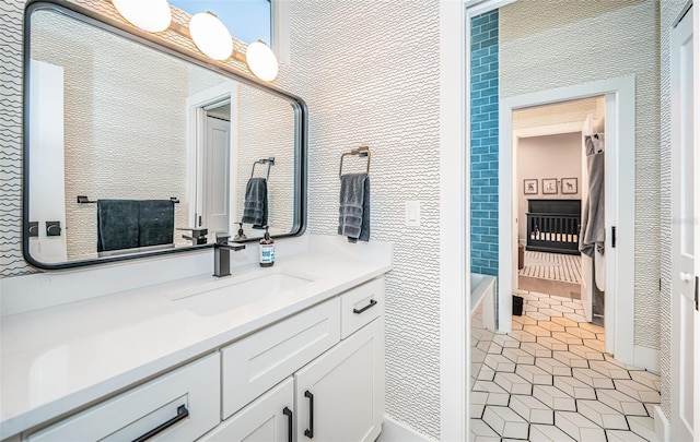 bathroom with tile patterned flooring, vanity, and a bathtub