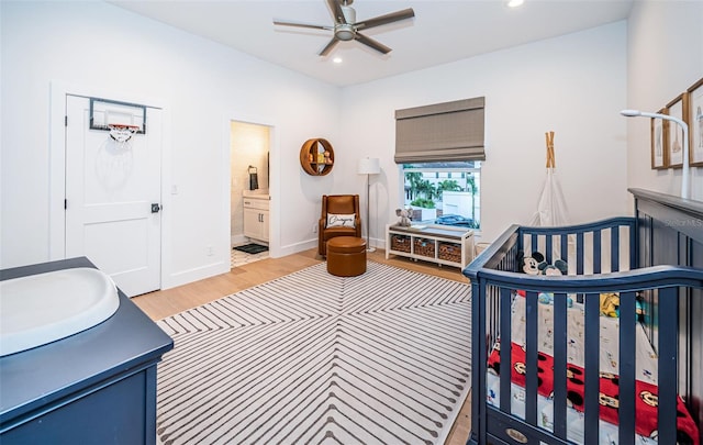 bedroom featuring hardwood / wood-style flooring and ensuite bathroom