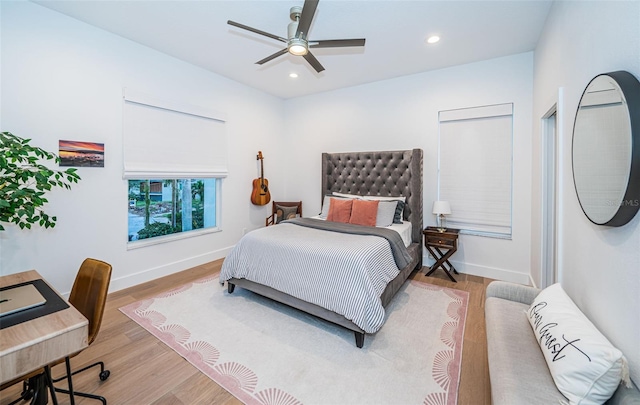 bedroom with ceiling fan and light wood-type flooring