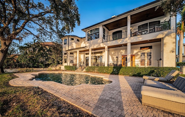 rear view of property featuring a balcony