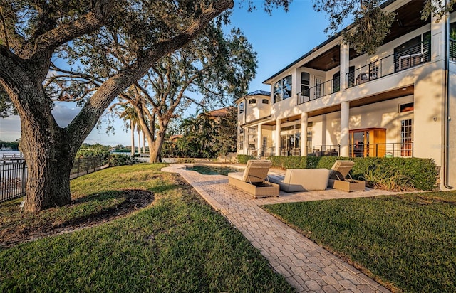 view of home's community with a pool, a yard, and a patio area