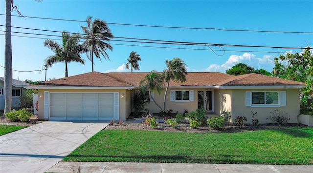 view of front of home with a garage and a front lawn