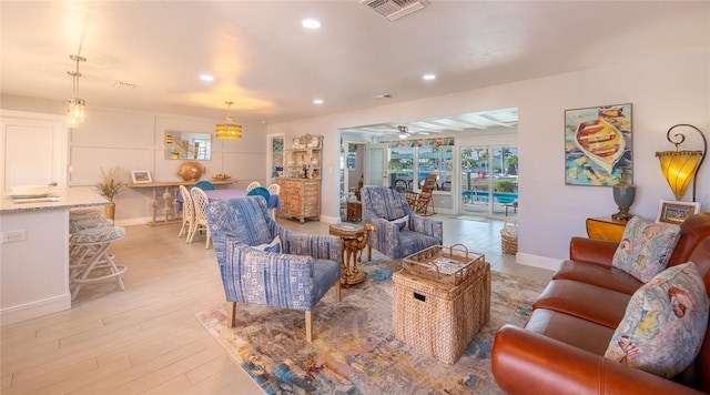 living room featuring ceiling fan and light hardwood / wood-style flooring