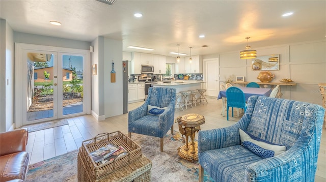 living room with french doors and light hardwood / wood-style floors