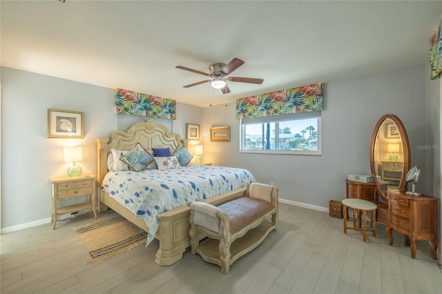 bedroom with ceiling fan and light hardwood / wood-style flooring