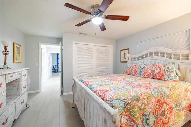 bedroom featuring a closet, light hardwood / wood-style flooring, and ceiling fan