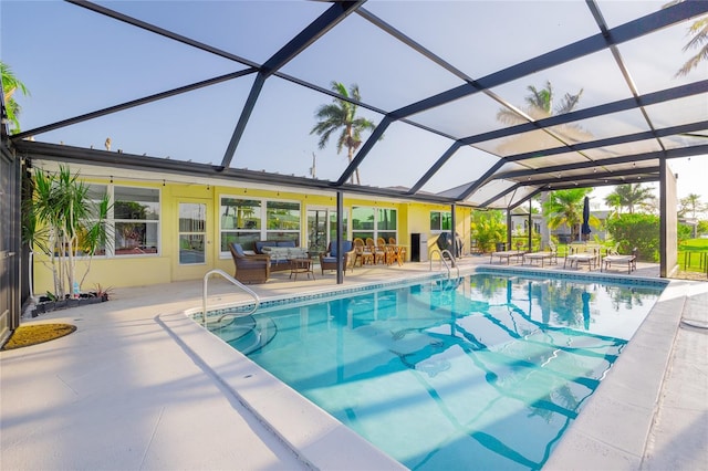 view of pool with glass enclosure, a patio area, and outdoor lounge area