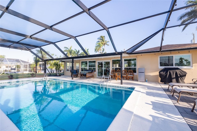 view of pool with a patio area and a lanai