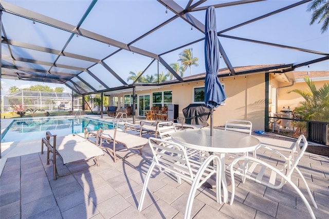 view of swimming pool with glass enclosure and a patio area