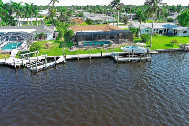 dock area featuring a lawn, glass enclosure, a swimming pool, and a water view