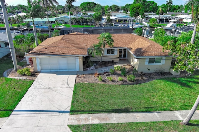 view of front of home with a front yard and a garage